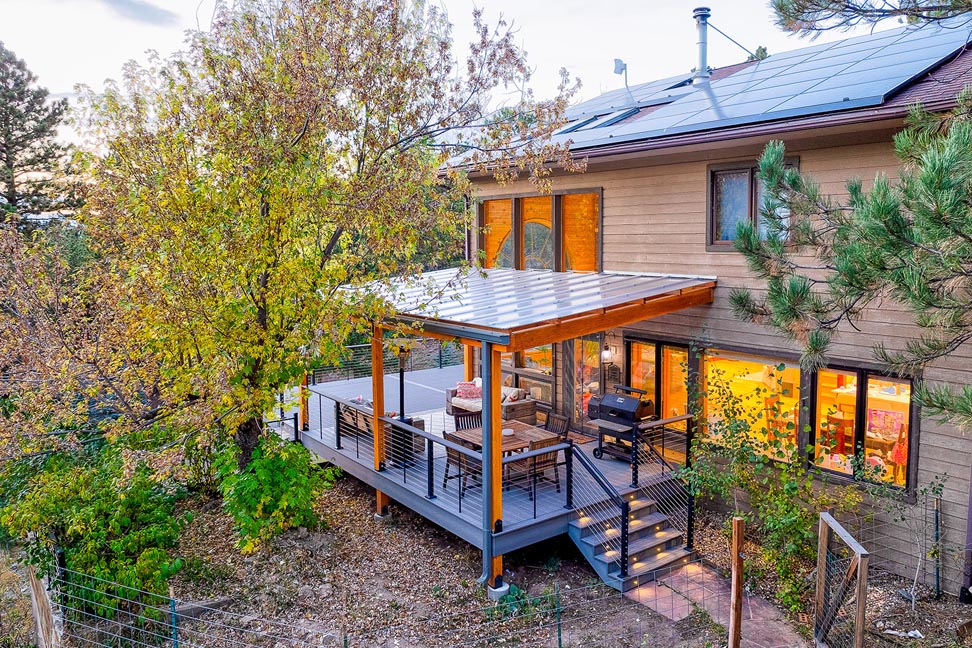 Home with pvc deck, aluminum and cable railing, attached pergola and steps lighting