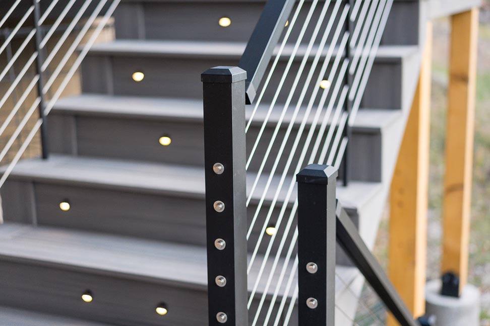 Custom deck with cable rail custom stairs and lighting in stairs