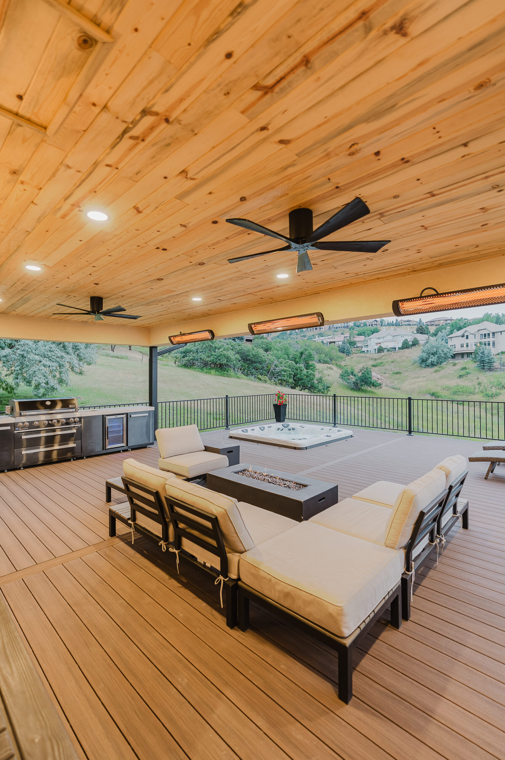 custom deck with custom cover seating heaters hot tub kitchen