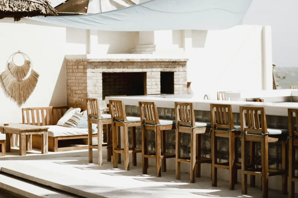 Outdoor bar with and a fireplace in the background